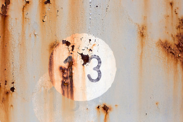  Number 13 on old painted and rusted metal panel