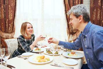 Young couple drinking and eating at the restaurant