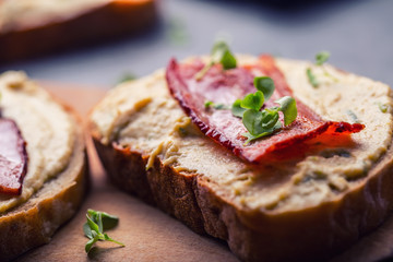 Spreads. Egg spread, grilled bacon, bread young basil leaves, Herb decoration. Ingredients: six eggs, spring onion, yeast, processed cheese, bacon, salt, pepper, various herbs decorations.