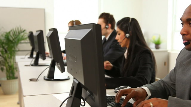 Group of customer service people at computers