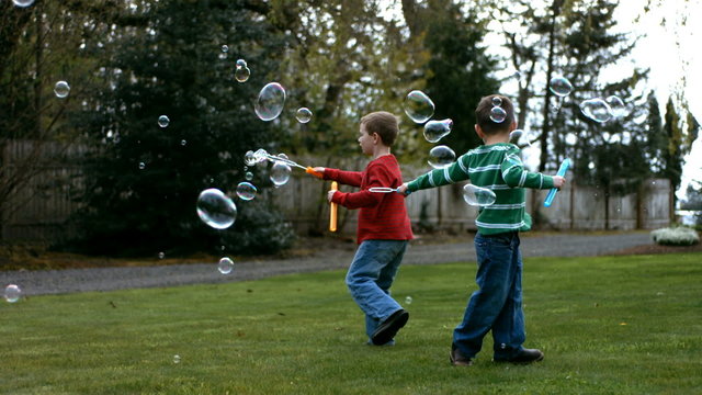 Boys making bubbles, slow motion
