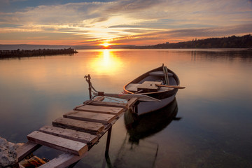 Beautiful light composition and mood of the boat at sunset