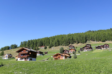 Typical house in the Swiss alps with blue sky