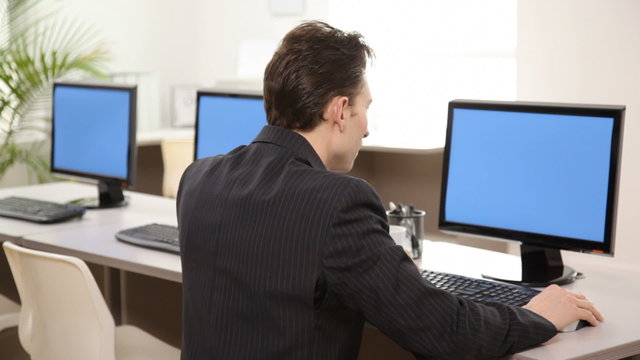 Businessman in office with computers