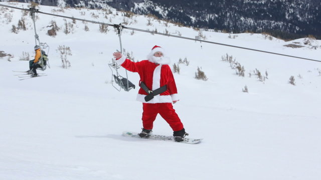 Santa Claus rides snowboard
