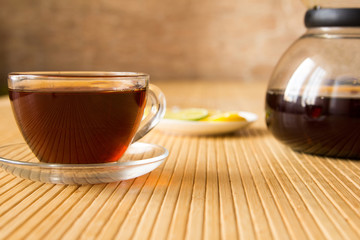 Black tea and a lemon on the table