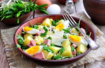 Salad of wild garlic with boiled potatoes, eggs, ham, parmesan and arugula