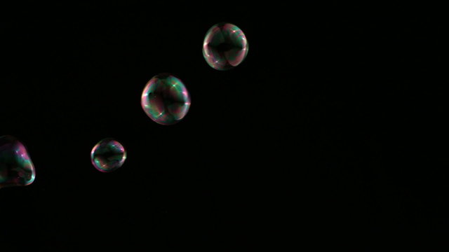 Colorful bubbles over black background