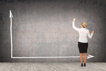 Business woman drawing on the wall.
