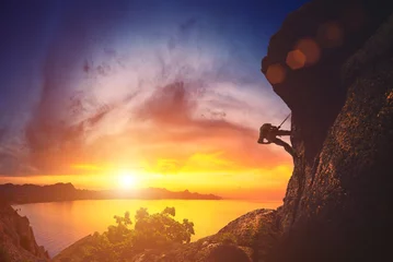 Foto op Plexiglas Climber against sunset © Bashkatov