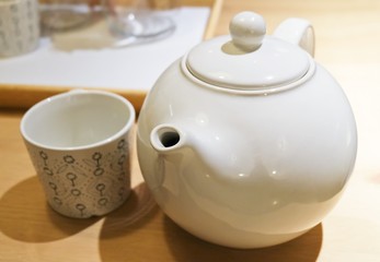 Tea Pot with Empty Tea Cup on The Table