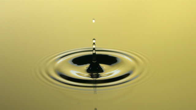 Yellow water drop, slow motion