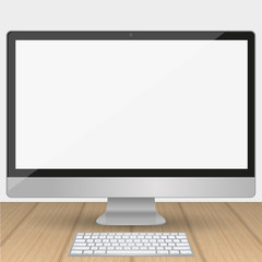 Computer display with blank white screen isolated on a wooden table in the interior