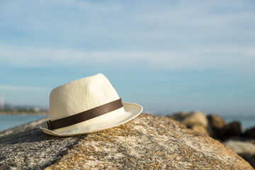 Hat on the rock at the beach