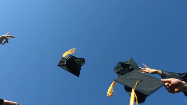 Throwing graduation caps into the air