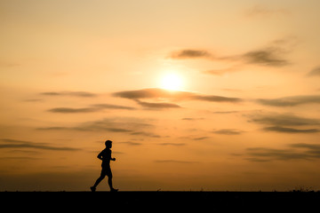 silhouette man jogging on the sunset background