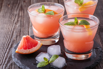 Grapefruit cocktail with ice and mint.