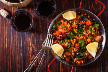 Paella with chicken, chorizo, seafood, vegetables and saffron se
