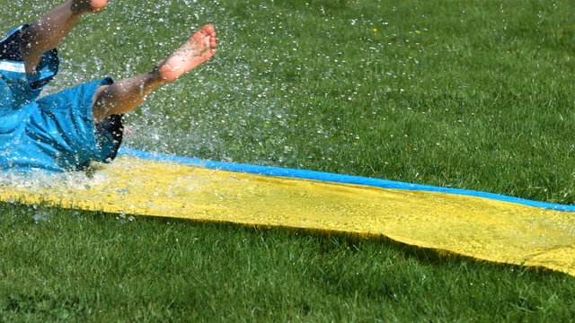 Boy on water slide, slow motion