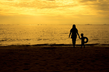 mother and son by on the sea