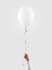 Hand hold blank white balloon mock up isolated. Baloon mockup. © Alexandr Bognat