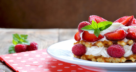 Belgian waffles with strawberries,raspberries and cream.