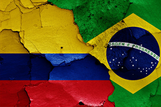 flags of Colombia and Brazil painted on cracked wall