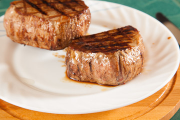 hot fresh grilled boneless rib eye steak isolated on white with barbecue grill marks in the meat