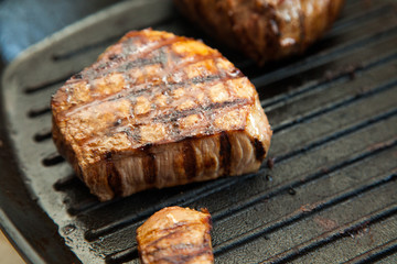grilled beef steak with rosemary on frying pan