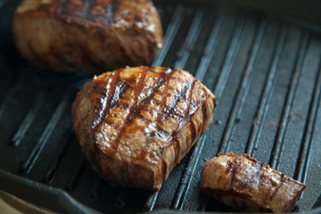 grilled beef steak with rosemary on frying pan