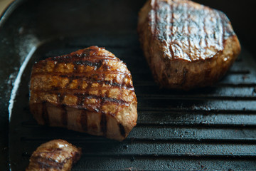grilled beef steak with rosemary on frying pan