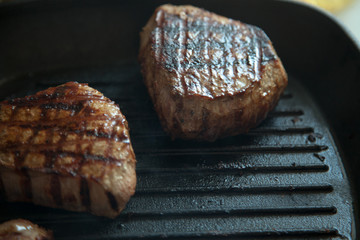 grilled beef steak with rosemary on frying pan