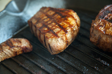 grilled beef steak with rosemary on frying pan