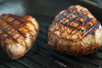 grilled beef steak with rosemary on frying pan