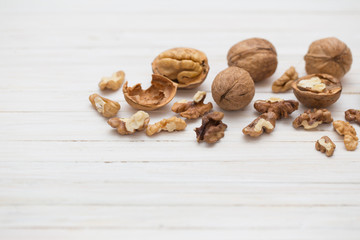 walnuts on white wooden background