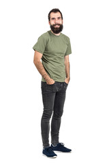 Naklejka premium Happy smiling bearded hipster with hands in pockets. Full body length portrait isolated over white studio background.