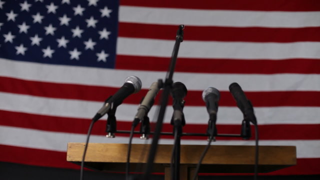 Microphone podium against american flag
