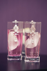 women's jeweler earrings and petals of roses.  violet