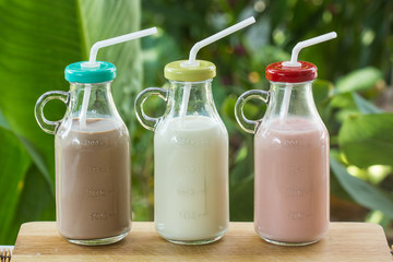 Strawberry, chocolate and fresh milk bottles