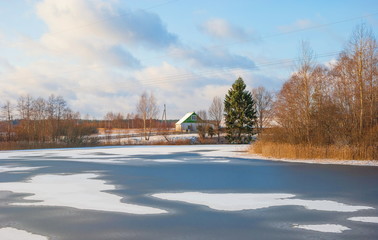 Spring landscape with a house near the river