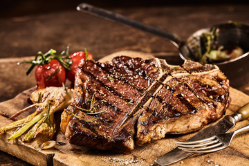 Prepared grilled porterhouse steak with fork and knife