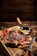 Roasted herbs and club rib steak with knife