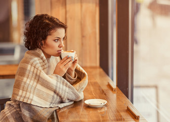 Pleasant woman drinking coffee