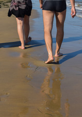 Young couple taking a stroll along the beach,summer holidays