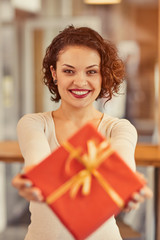 Pleasant woman giving present.  