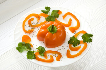 chopped orange pepper on  round white plate