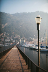 Lantern on the pier of a mountain lake Como in Italy