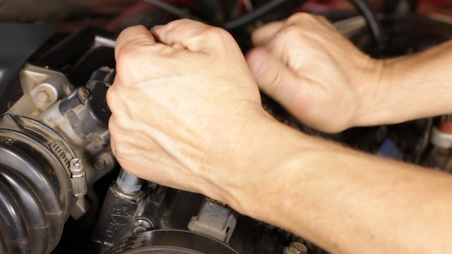 A mechanic working on a car