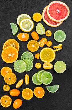 Grapefruit, orange, tangerine, lemon, lime and kumquat on black