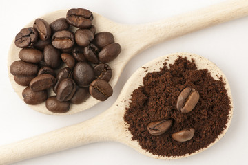 three coffee beans and on coffee  powder